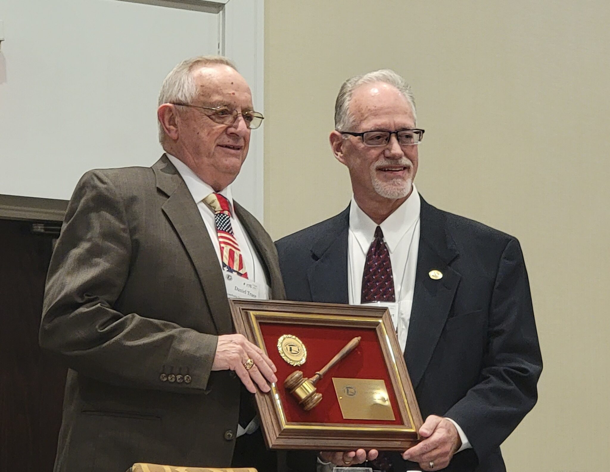 Left to Right: Daniel Trace being presented a plaque by Michael Calvert